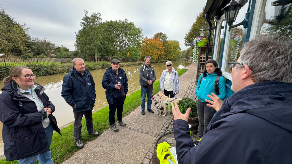 The group of people on the towpath in Loughborough, including Tim and Tracey Clarke from the Accessible Waterways Association and senior members of the Canal and River Trust towpath team.